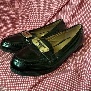 Shiny black and gold patent loafers.